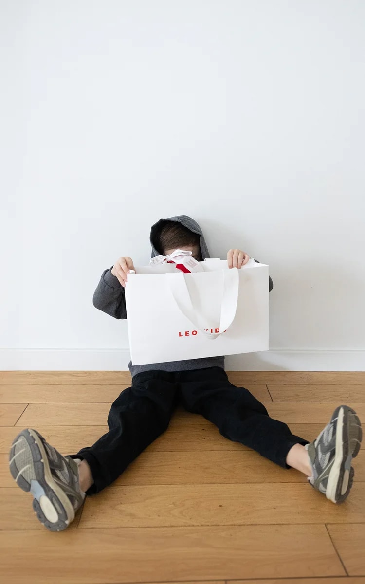 Child sitting in stylish clothing